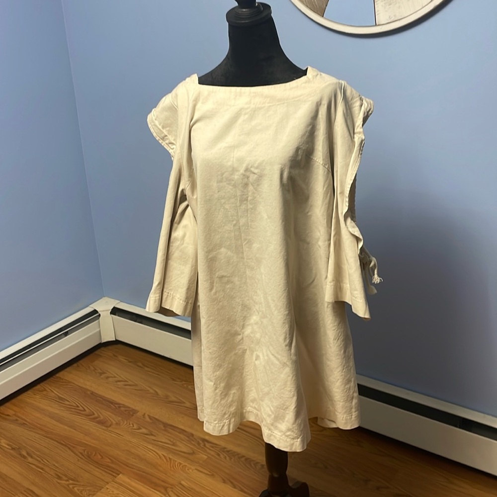 Cream color, open on the arms. Bought at boutique. Like new, smoke free home.